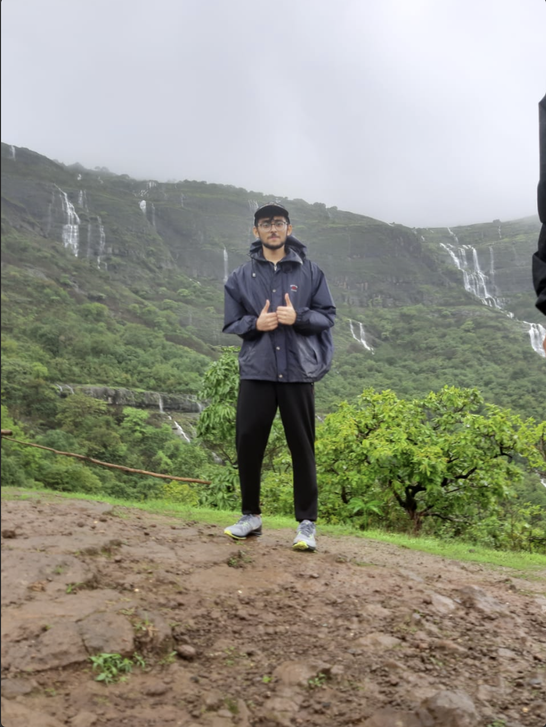 Standing with monsoon waterfalls cascading in the background